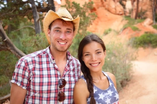 Man in Cowboy Hat Posing with Brunette Woman - FarmersOnly