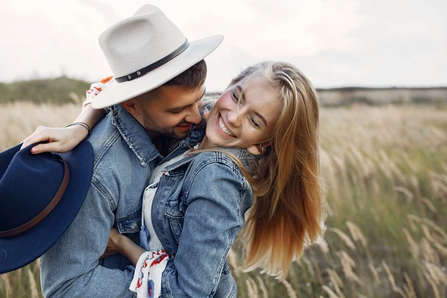 Couple hugging in a wheat field