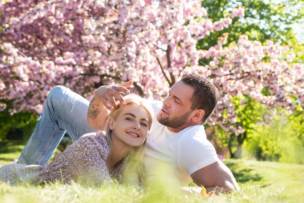 Couple hanging out in the grass on an outside date