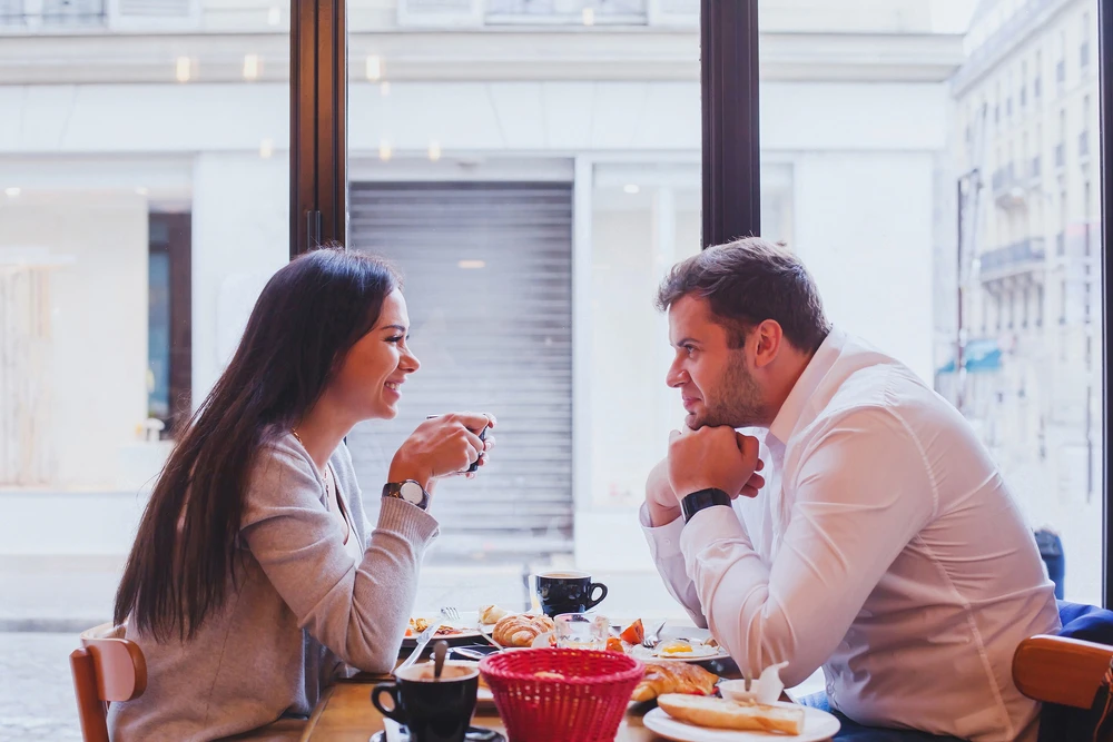 Man and woman having coffee at a restaurant - FarmersOnly