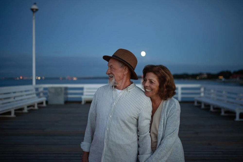 Older couple embracing each other during dusk, FarmersOnly