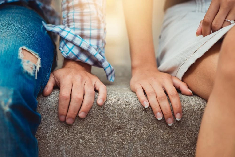 Close up of a pair of hands of a young couple on a first date