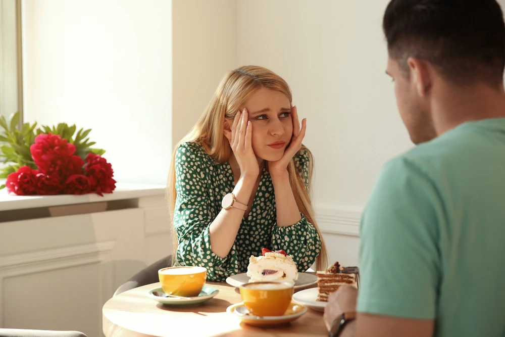 Young woman having a bad time on a first date